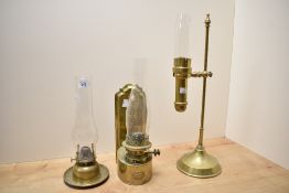 A Messenger & Sons brass oil lamp having glass chimney, h37cm, sold together with two others, (3)