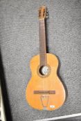 A vintage Spanish guitar, labelled Hijos De Vicente Tatay, SRC, heavy signs of wear, with vinyl