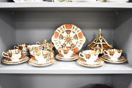 An Abbeydale Canton bone china dinner service, decorated in the Old Imari style pattern, to