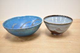 A studio pottery style bowl having grey and brown patterns, raised on a circular footed base,