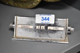 A vintage chrome cased day/date desk calendar , of small proportions, width approx. 13cm, in need of