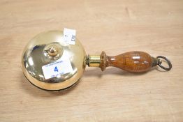 A rag pickers/muffin man brass bell having turned walnut handle, L19cm