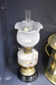 An early 20th century brass oil lamp having frosted floral glass shade, h46cm