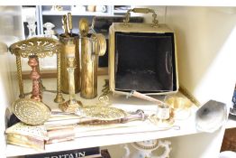 A quantity of brass and copper ware, to include a coal scuttle, candle stick, pan and fire tools