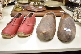 A pair of wooden clogs, L26cm, sold together with a pair of red leather childs shoes, (4)