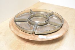 A 20th century teak wood rotating tray having multiple smoke glass dishes, w35cm