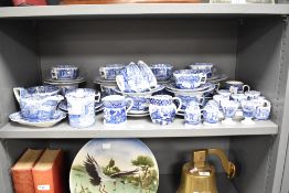 A Spode 'Willow' pattern dinner service decorated with blue and white landscape scenes and