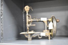 A Victorian child's sewing machine, w21cm x h20cm