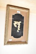An Oriental soapstone or similar mythical figure, framed behind glass in sealed gilt wood frame,