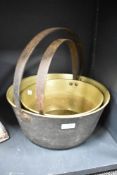 An early 20th century brass jam pan, w35cm, sold together with 1 other, (2)