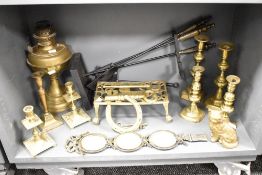 An early 20th century brass trivet, L26cm, sold together with brass candlesticks and an oil lamp
