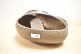 A vintage Coco de Mer, having simplistic carved decoration, modelled into trug/basket shape,