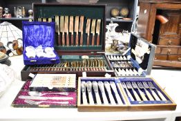 A canteen containing cutlery each having tapered wooden handles and yellow metal terminals, sold