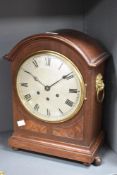 An early 20th century mahogany 8 day mantle clock having silvered Roman dial and ball feet, h39cm