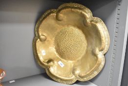 An early 20th Century brass ornamental scalloped bowl of rosette form having impressed marks to