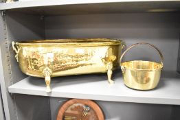 A brass jardiniere of oval form having recumbent handles and raised on paw feet, L55cm, sold