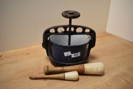 A blue enamel and black metal meat/cheese press, w18cm, sold together with a Wedgwood and Spode