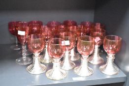 A quantity of cranberry glasses, largest h16cm, approx 19