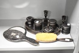 An ebony dressing table set, to include a pair of mirrors, brush and candlesticks ect, (11)