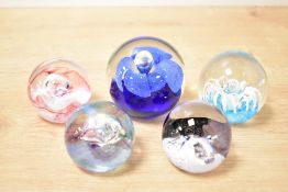 A Caithness 'Mooncrystal' pattern glass paperweight, h5cm, sold together with four similar