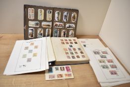 A cigarette picture album containing locomotive, The silver jubilee and various stamps ect