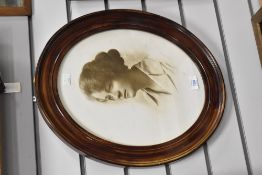 A portrait of a young lady held within an oval frame, 47cm x 40cm overall