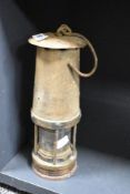 An early 20th century miners lamp, h28cm