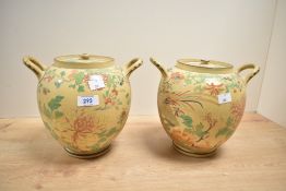 A pair of Wedgwood vases with covers, decorated with exotic birds and foliage patterns, impressed