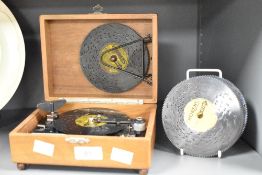 An early 20th century disc-play music box with discs stamped Switzerland, L18.5cm