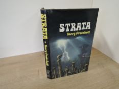 Literature. First Edition. Pratchett, Terry - Strata. London: Colin Smythe, 1981. In dust jacket. (