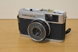 An Olympus Trip 35 35mm film camera, with a built in Olympus D Zuiko 40mm f2.8 lens.