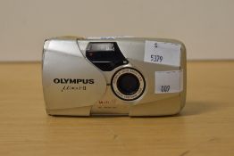An Olympus Mju II, ultra compact 35mm camera, with built in 35mm f2.8 lens.