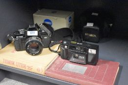 A Minolta X-700 camera with Minolta MD 1:1,7 49mm lens and Minolta AF-E with 1:3,5 35mm lens sold
