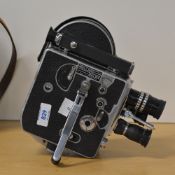 A Paillard Bolex 16mm movie camera, with hand grip, viewfinder, three reels, telephoto lens, zoom