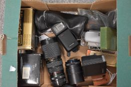 A box of various meters, flash shoes, and lenses. A MV Metrovic, a Glossan Sixan, Zeiss Ikon