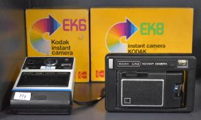 Two Kodak Instant cameras. An EK8 and an EK6