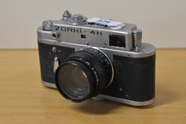 A Zorki 4K 35mm rangefinder camera with Jupiter-8 50mm f/2 Lens, with black leather case and strap.