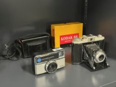 A Kodak 155X Instamatic camera and a Kodak 66 folding camera