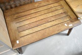 A teak slatted coffee table having splay legs, approx. 76 x 45cm