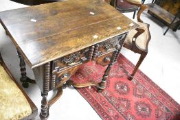 A Jacobean revival oak side table having single frieze drawer , turned legs with scroll feet and