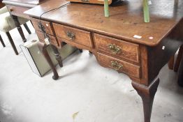A nice quality reproduction oak writing desk/lowboy, having some age with Georgian style handles and