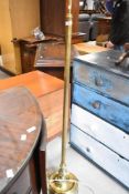 A vintage brass standard lamp having reeded column and claw feet