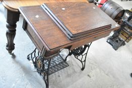 A vintage oak treadle sewing machine table (no machine)