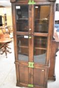 A late 19th or early 20th Century oak display cabinet of narrow proportions, width approx. 64cm