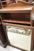 An Edwardian mahogany bookshelf and a mahogany framed wall mirror