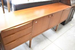 A vintage teak long john style sideboard, width approx. 214cm