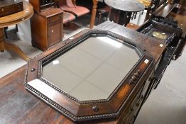 An early 20th Century oak framed canted wall mirror, width approx. 69cm