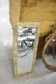 A modern mosaic effect wall mirror, approx. 85 x 34cm