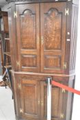 A late 19th or early 20th Century oak full height corner cupboard, height approx. 192cm