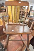 A vintage childs spindle back rocking chair